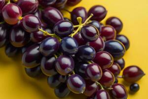 ai generado manojo de rojo uvas en un amarillo fondo, de cerca. ai generado foto