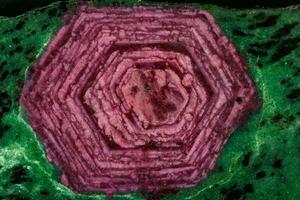 Macro of mineral stone ruby in rock on black background photo