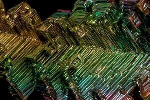 Macro of the stone bismuth mineral on a black background photo
