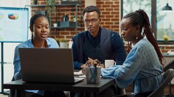 Office workers planning business project, talking about solutions to increase company profit. Modern partners collaborating to create research presentation with annual reports and data analytics. photo