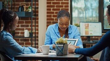 Young people finding startup solutions to increase business profit, reading statistics and annual reports on documents. Executive workers checking analytics plan in coworking space. photo