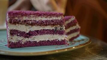 cutting A piece of purple velvet cake with cream video