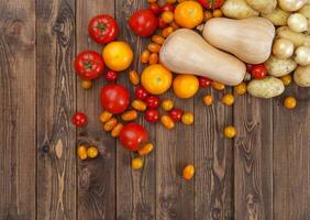 Farm vegetables on wooden table, top view photo