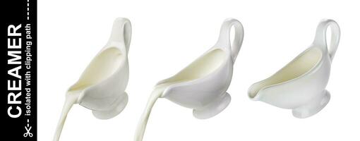 Pouring cream from creamer isolated on white background, flowing milk photo
