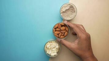 almond powder and almond in a jar on table, video