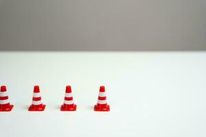 The end of a row of traffic cones on a white background. Provide new sanctions and restrictions. Laws and regulations. Bans and taboo. Stop work, freeze and cancel. Block VPN services. photo