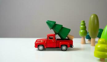 An old pickup truck takes out the Christmas tree from the forest. Christmas and new year. Preparation for the holidays. photo