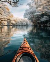 ai generado un atractivamente decorado kayac es flotante pasado nieve cubierto arboles en un lago foto