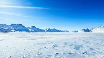 AI generated A serene winter landscape showcasing a snow covered mountain range under a clear blue sky with a frozen lake in the foreground with empty space for text photo