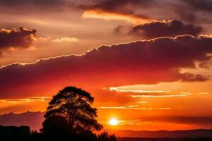 ai generado un puesta de sol terminado el montañas con un árbol en el primer plano foto