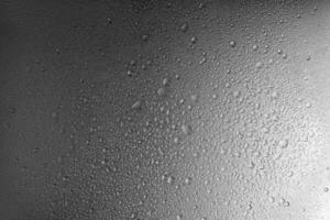 Water drops on gray metal background texture with smooth transition of lighting photo