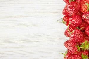 Strawberry on white wooden background photo