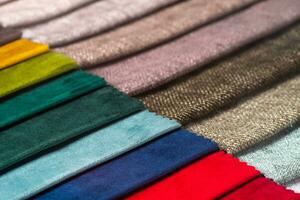 Multi colored set of upholstery fabric samples for selection, collection of textile swatches photo