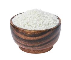 Basmati rice groats in wooden bowl isolated on white background photo