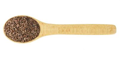 Flax seeds in wooden spoon isolated on white background photo