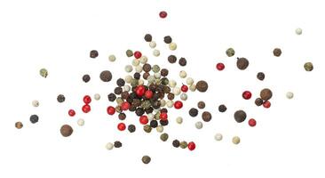 Heap of black, red, white and allspice peppercorns isolated on white background, top view photo