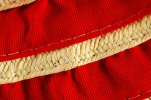 closeup of red fabric with woven trim photo