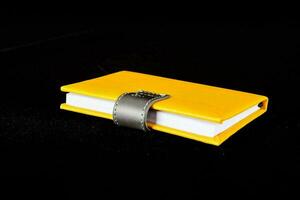 a yellow leather book with a buckle photo