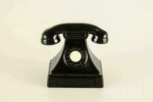 a black telephone on a white background photo