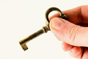 a person holding an old key photo