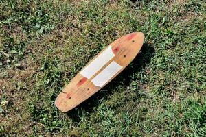 a wooden skateboard on the grass photo