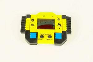 a yellow and black electronic game with blue buttons photo