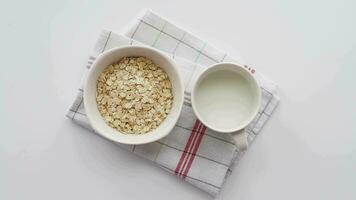 top view of roasted oats flakes and milk on table video