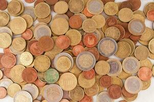 a pile of coins on a white background photo