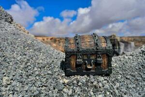 a small wooden chest sitting on top of a rocky hill photo