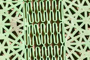 a close up of a green metal grate photo