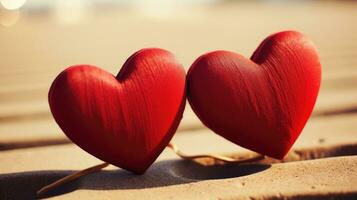 ai generado dos corazones en playa arena a romántico puesta de sol foto
