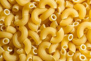 Uncooked Chifferi Rigati Pasta. A Culinary Canvas of Chifferi Rigati, Creating a Lively and Textured Background for Gourmet Cooking. Dry Pasta. Raw Macaroni - Top View, Flat Lay photo