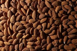 Scattered Almonds. Background from Almond Nuts. Natural High-Calorie Snacks photo