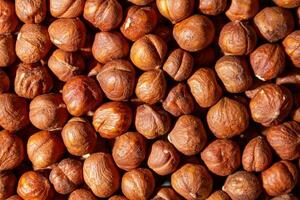 Scattered Peeled Hazelnut - Top View. Background from Hazelnuts. Natural High-Calorie Snacks photo