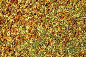 Vibrant and Colored Vegetable Seasoning Mix. A Culinary Canvas of Aromatic Seasoning - Textured Background for Gourmet Cooking. The Harmonious Combination of Fresh Herbs and Spices - Top View photo