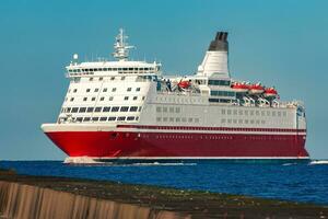 Red cruise liner. Large passenger ferry underway photo