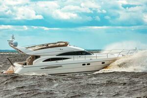 White speed boat moving fast to the Baltic sea. Water sport photo