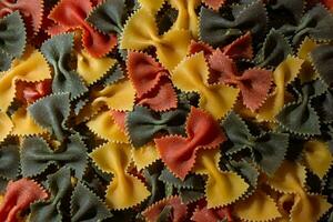 Uncooked Vibrant Colored Farfalle Pasta. A Culinary Canvas of Multicolored Bow-Tie Macaroni, Creating a Lively and Textured Background for Gourmet Cooking Enthusiasts. Colored Dry Pasta. Raw Macaroni photo