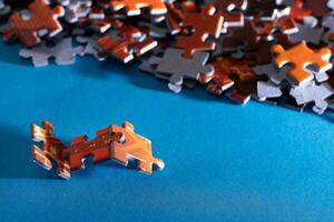 Mixed Peaces of a Colorful Jigsaw Puzzle Lie on the Blue Background Strategy and Solving Problem Concept photo