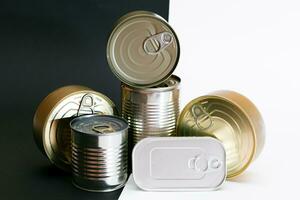 A Group of Stacked Tin Cans with Blank Edges on Split Black and White Background. Canned Food. Different Aluminum Cans for Safe and Long Term Storage of Food. Steel Sealed Food Storage Containers photo