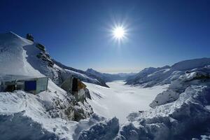 View of the nature trail, glaciers and sunlight shining in the beautiful morning Grindelwald First, Mount Eiger, the highest peak, Switzerland Alps For activities such as hiking, trekking, climbing. photo