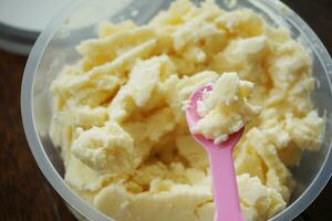 a closeup shot of a bowl of butter cake and spoon photo