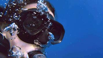 Scuba girl diving underwater in Koh Tao Thailand close up watching up smiling video