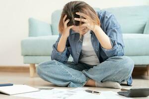 Stressed and headache asian woman with large bills or invoices no money to pay to expenses and credit card debt. shortage, Financial problems, mortgage, loan, bankruptcy, bankrupt, poor, empty wallet photo
