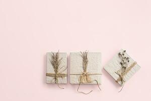 Ecological gift boxes decorated dried flowers. Zero waste holidays. photo