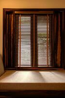 Light coming through wooden window blinds into living room. photo