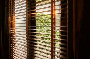 Open wooden window blinds, close up. photo