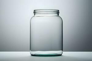 Empty glass jar on gray background photo