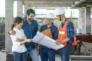 Newly wed couple is meeting with engineering contractor at their under construction house to inspect the building progress and quality control for home ownership and real estate development photo