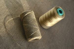 Skeins of thread on burlap. Yellow threads on coarse cloth. photo